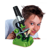 Load image into Gallery viewer, Child holding a toy microscope with a white background
