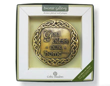 Load image into Gallery viewer, Bronze wall plaque with 'God bless our home' text in a box, branded 'Celtic Shadows'.
