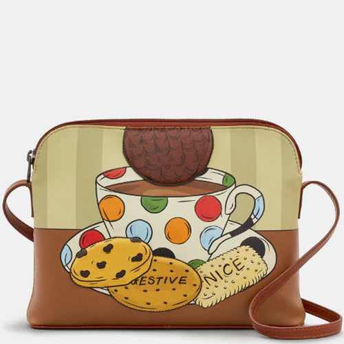 Crossbody bag with a design of a polka dot teacup, cookies, and a cookie jar on a beige background.