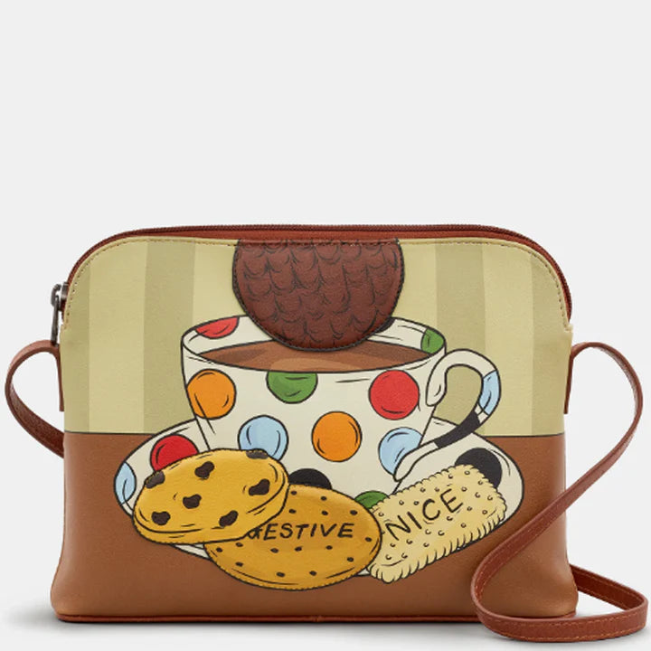 Crossbody bag with a design of a polka dot teacup, cookies, and a cookie jar on a beige background.